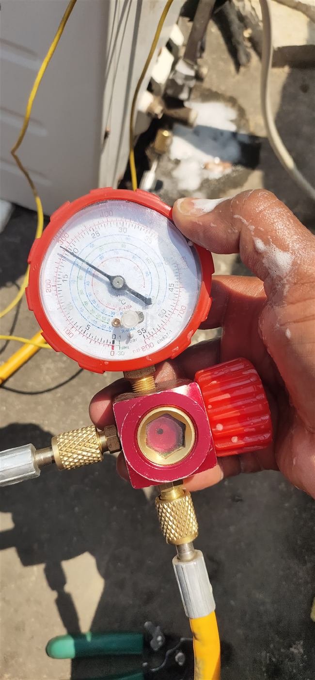 AN Repair Services technician checking AC refrigerant gas pressure with a manifold gauge in Kamareddy