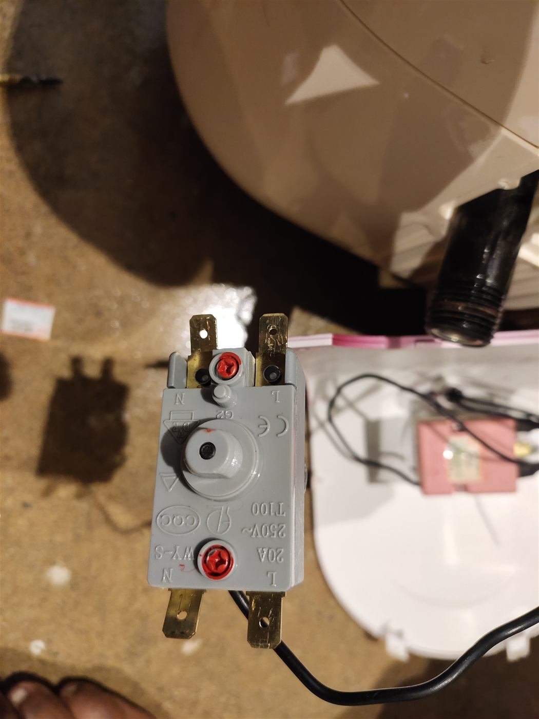 Geyser cut-off thermostat (250V, 20A, T100) removed for testing during a repair in Kamareddy