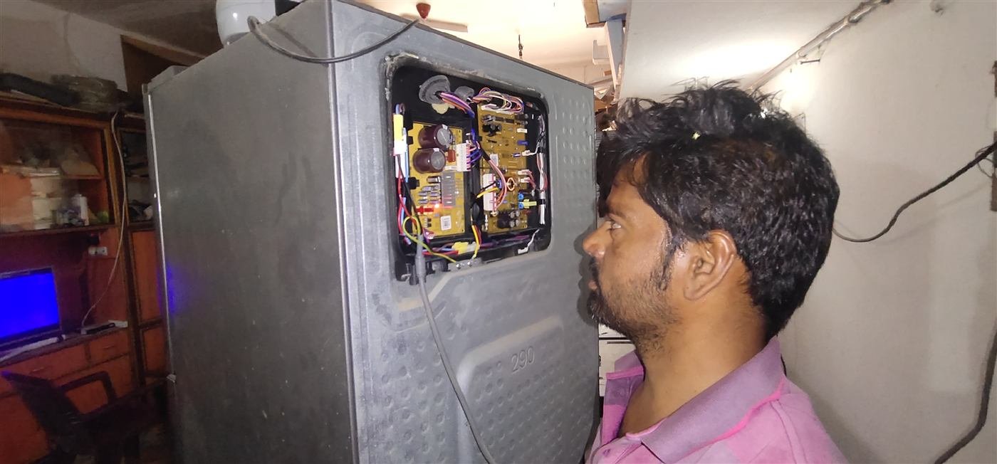 Close-up of a refrigerator circuit board being diagnosed by an AN Repair Services technician