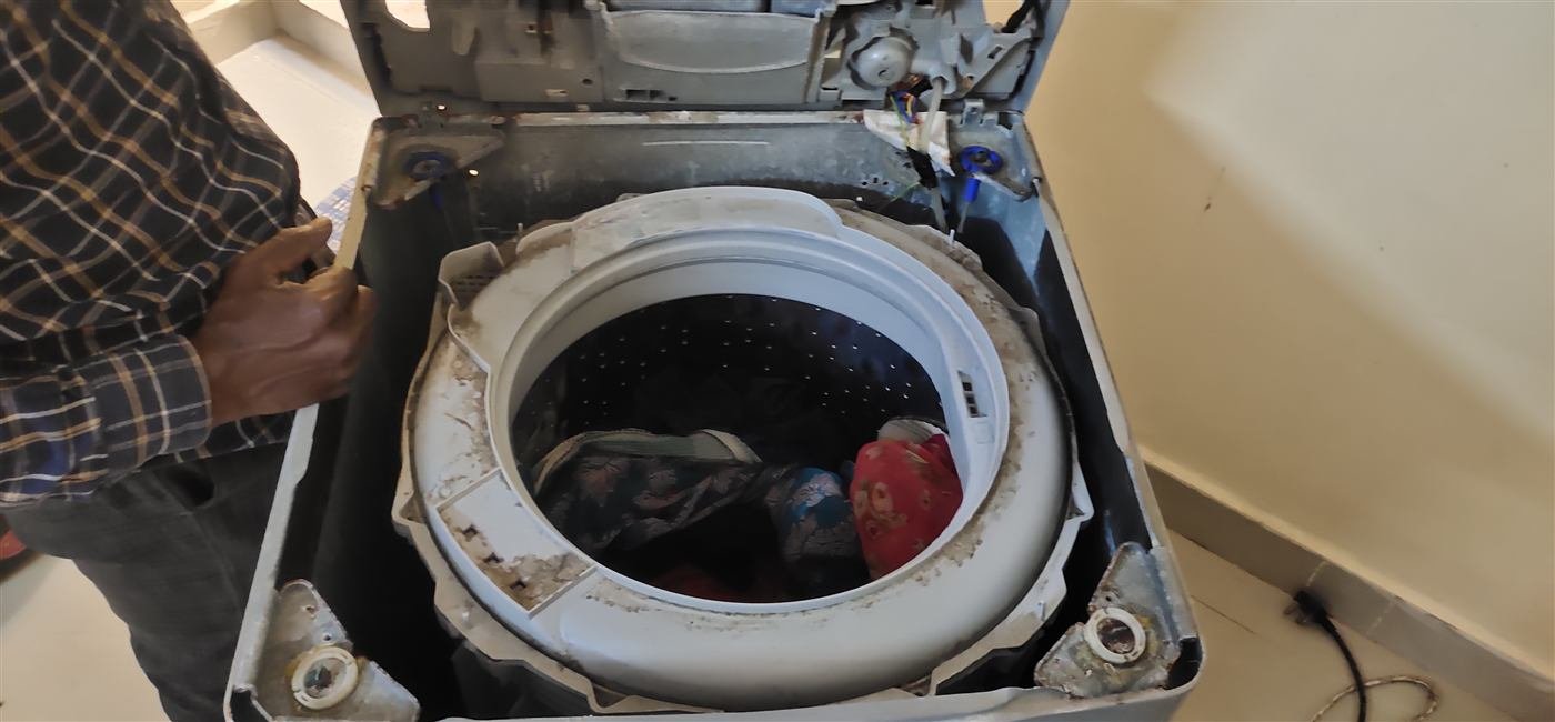 AN Repair Services technician repairing a washing machine at a customer's home in Kamareddy